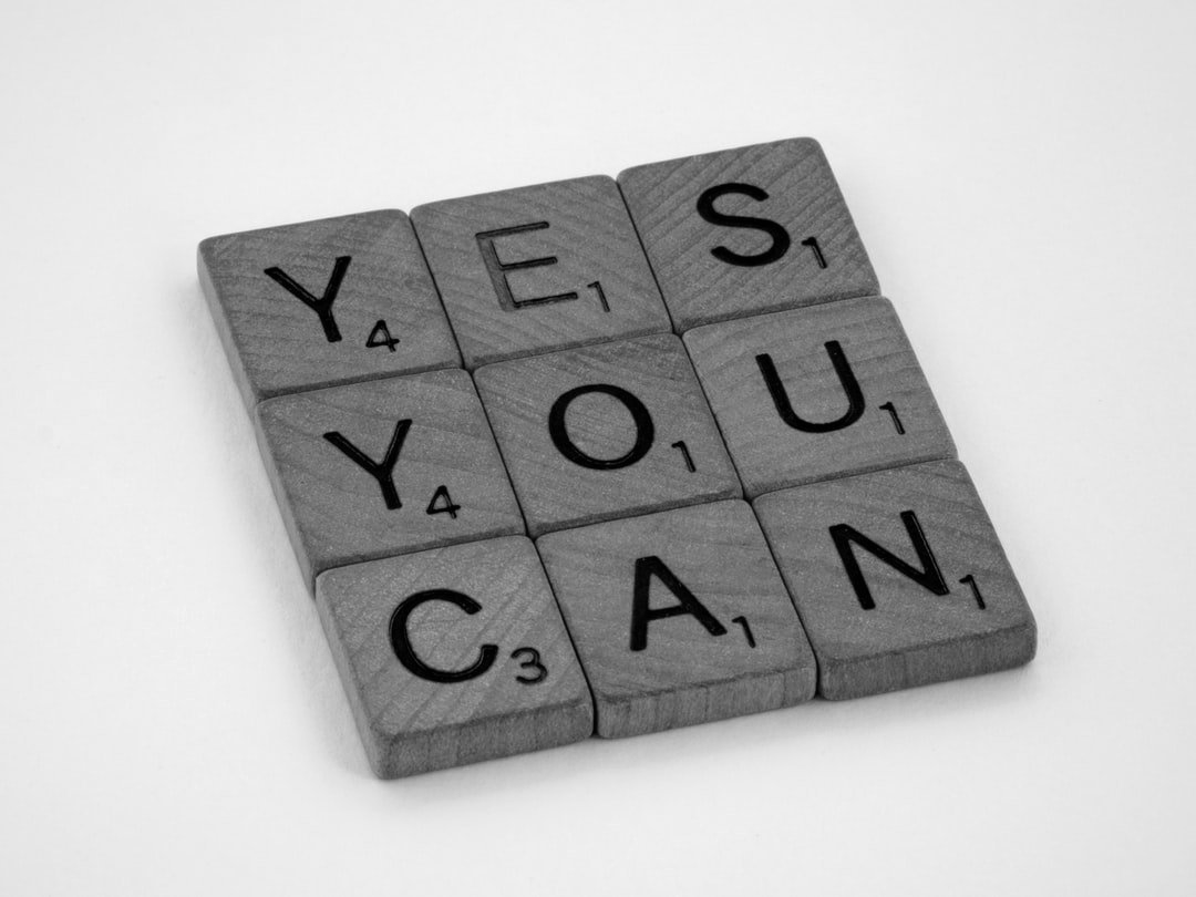 Grey letter tiles spelling “YES, YOU CAN.” on a light background